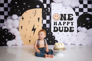 Sitting milestone baby posed in a prop and smiling with a cute backdrop. San Antonio baby photographer. Best photographer in San Antonio
