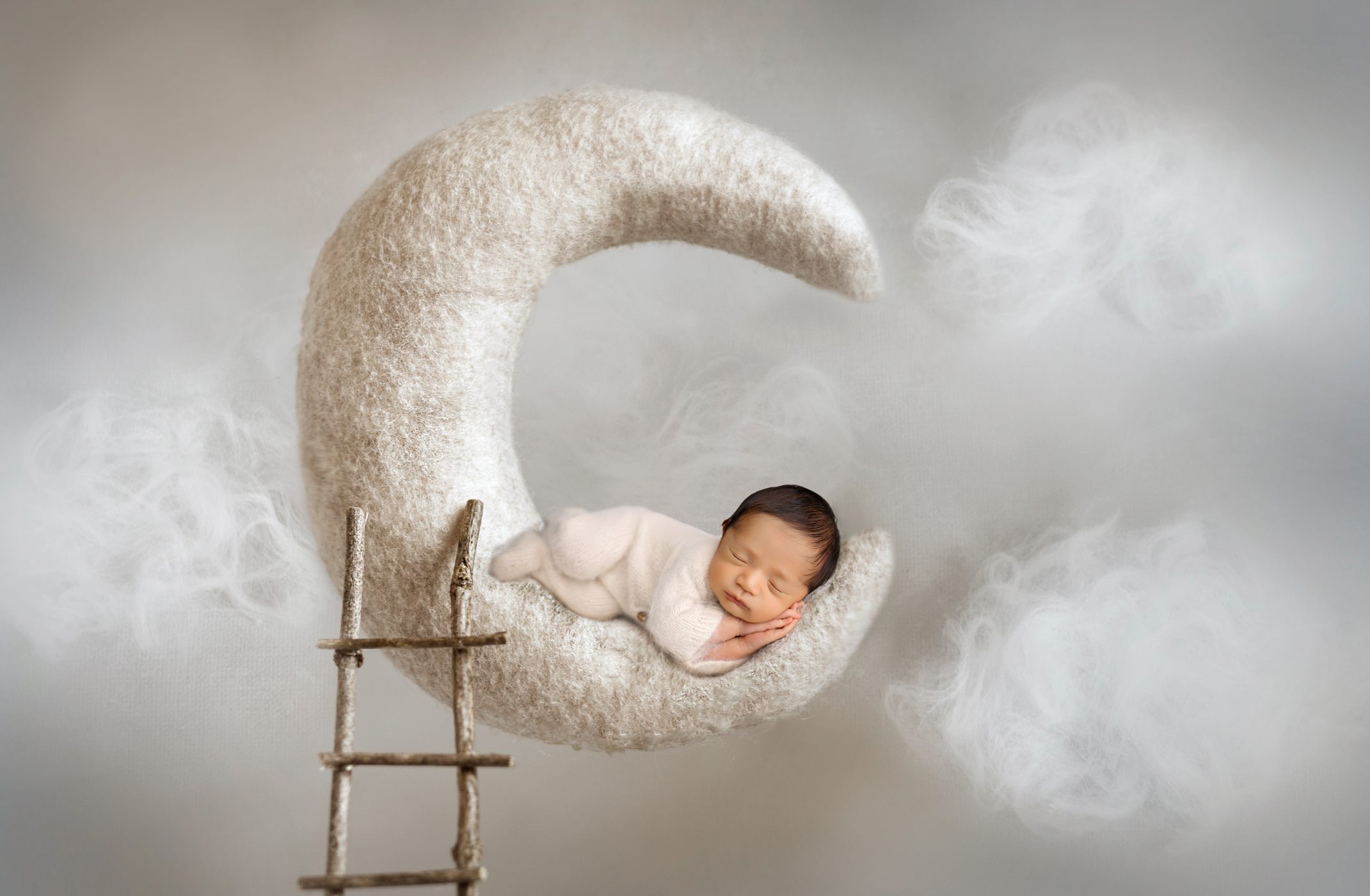 Newborn photoshoot in san antonio Texas. Baby is sleeping and posed on a moon. Photoshoot done by San Antonio photographer, Krystal Garcia Photography