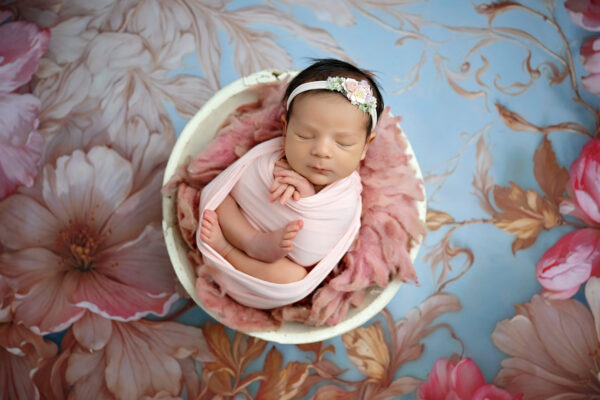 San Antonio newborn photographer captures sleeping newborn baby curled up in pose in a prop