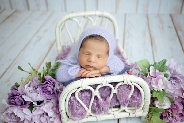 top san antonio newborn photographer photographs newborn sleeping on a bed