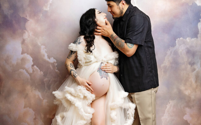 Dreamy cloud backdrop maternity session in ivory gown