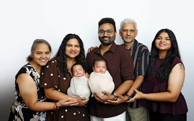 Extended family posing with newborn twins during a San Antonio newborn photography session