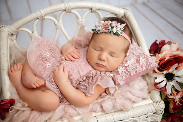 Baby girl in blush floral newborn setup | San Antonio newborn photographer
