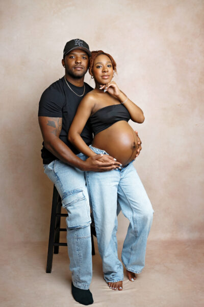 Expecting couple posing together during a modern studio maternity session in San Antonio.