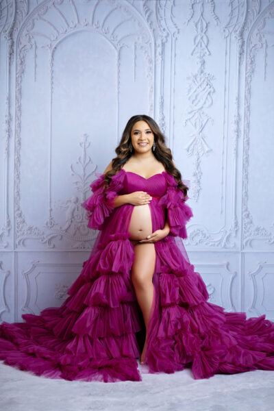 Magenta gown:
Pregnant mother wearing luxury magenta designer maternity gown during San Antonio maternity photoshoot