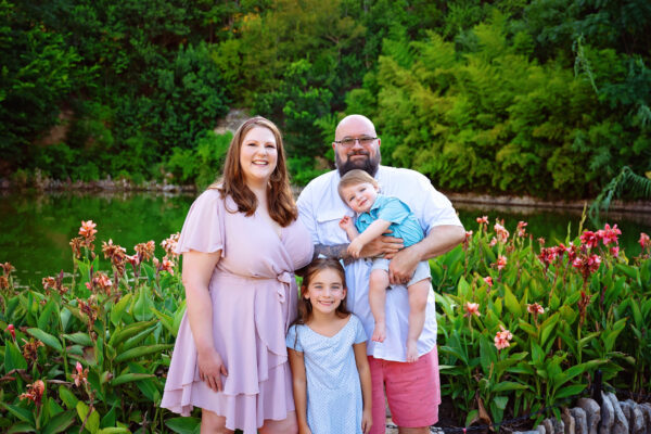 Parents and grandchildren smiling together during an outdoor family portrait session in San Antonio