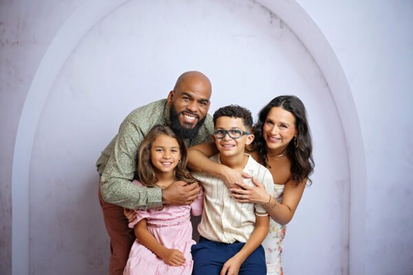 Expecting parents smiling with their son and daughter during a San Antonio studio maternity session